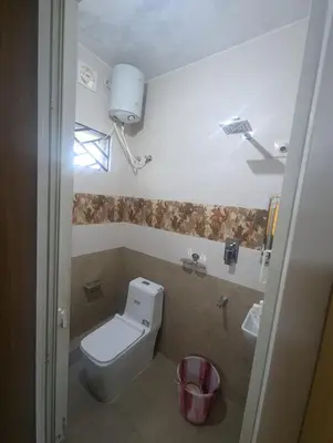a bathroom with a toilet and a sink at Ivy hostel ooty in Ooty