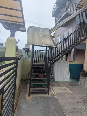 a staircase leading to a house with a light at Ivy hostel ooty in Ooty