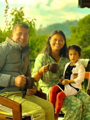 a man and a woman and a child holding cups at Mount Lux Villa in Devāla