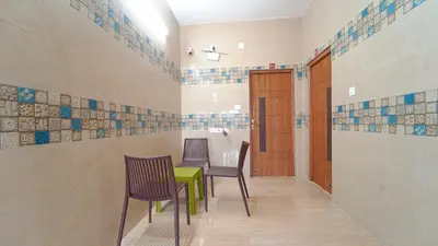 a dining room with a green table and chairs at Citrus stays Nr bosch,infosys kalapatti in Coimbatore