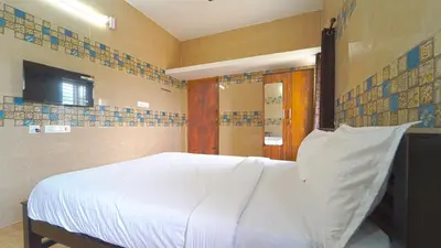 a bedroom with a white bed and a television at Citrus stays Nr bosch,infosys kalapatti in Coimbatore