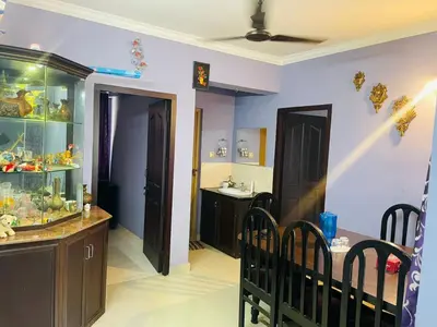 a room with a aquarium and a dining table and chairs at 2BHK Apartment in Central Thrissur in Trichūr