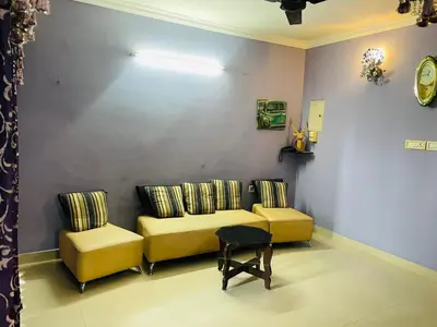 a living room with a couch and two chairs at 2BHK Apartment in Central Thrissur in Trichūr