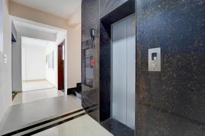 a hallway with a glass door in a building at Palette Serenity by CheckIn | 2 BHK Apartment | Coimbatore in Coimbatore