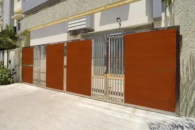 a pair of wooden gates on a building at Palette Serenity by CheckIn | 2 BHK Apartment | Coimbatore in Coimbatore