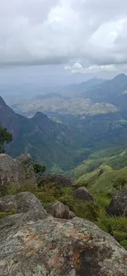 a view from the top of a mountain with rocks at Dadysmud house in Kottakamboor