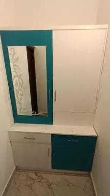 a mirror on top of a dresser in a bathroom at Dolmens castle in Marayoor