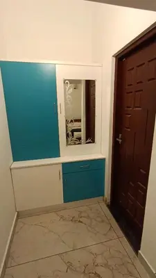 a room with a door and a mirror on the wall at Dolmens castle in Marayoor
