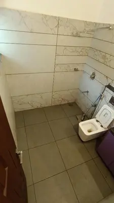 a bathroom with a toilet in a room at Dolmens castle in Marayoor