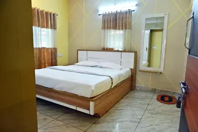 a bedroom with a large bed and a mirror at Suhas Nest in Mysore
