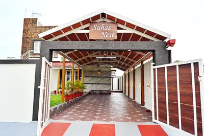 a building with a sign that reads shias nest at Suhas Nest in Mysore