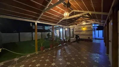 an empty lobby of a building with a green yard at Suhas Nest in Mysore