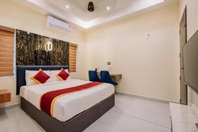 a bedroom with a bed and a desk at Victoria Suites Airport Hotel in Nedumbassery