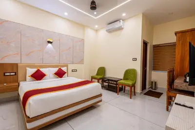 a hotel room with a bed and a desk at Victoria Suites Airport Hotel in Nedumbassery