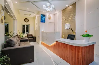 a living room with a couch and a counter at Victoria Suites Airport Hotel in Nedumbassery