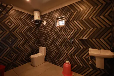 a bathroom with a toilet and a sink at MT'S Villas in Batheri