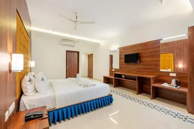 a hotel room with a bed and a television at Kamath Village Resortz