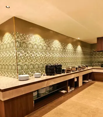 a kitchen with a bunch of dishes on a counter at Parays Fernwoods in Mannārakkāt