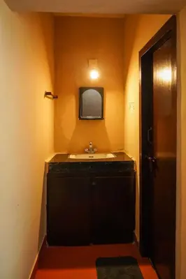 a bathroom with a sink and a mirror at Hertz home in Ooty