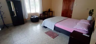 a bedroom with a bed and a tv in it at Perch by the sea 2 in Kannur
