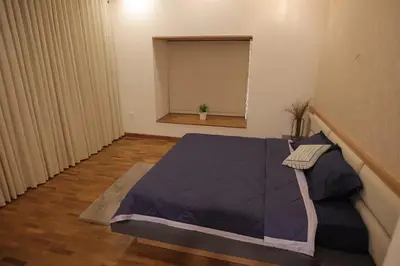 a room with a bed and a window at Mon Reve in Kozhikode