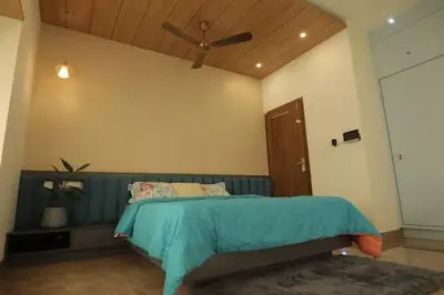 a bedroom with a bed with a ceiling fan at Mon Reve in Kozhikode