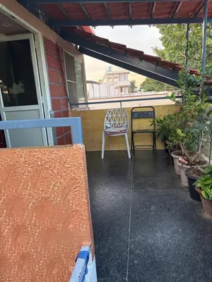 a patio with a bench and a chair on a porch at Private Room with Kitchen for Decent Couples & Families in Mysore