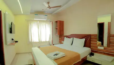 a bedroom with a large bed in a room at Parva Residency in Palladam