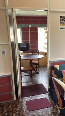 a room with a table and a chair in a room at Garden Room for a Couple in Mysore