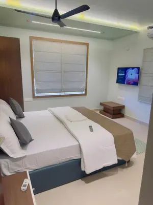 a bedroom with a large bed with a window at Bayfront Bliss - Flat 3BHK in Calicut Beach-Wakeup to stunning views in Kozhikode