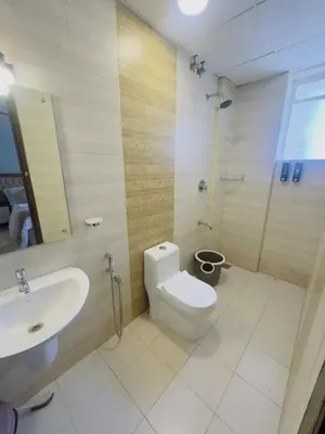 a bathroom with a white toilet and a sink at Bayfront Bliss - Flat 3BHK in Calicut Beach-Wakeup to stunning views in Kozhikode