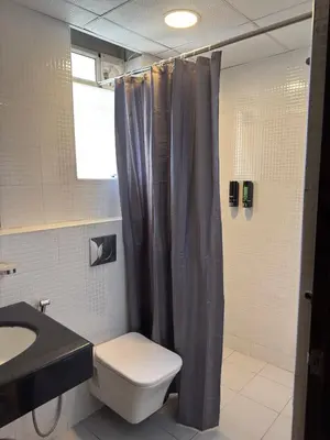 a bathroom with a toilet and a sink and a shower at Bayfront Bliss - Flat 3BHK in Calicut Beach-Wakeup to stunning views in Kozhikode