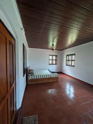 a bedroom with a bed in a room with a wooden ceiling at Traditional Kerala house, Thalassery, Kannur in Tellicherry
