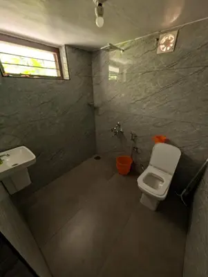 a bathroom with a toilet and a sink at Traditional Kerala house, Thalassery, Kannur in Tellicherry