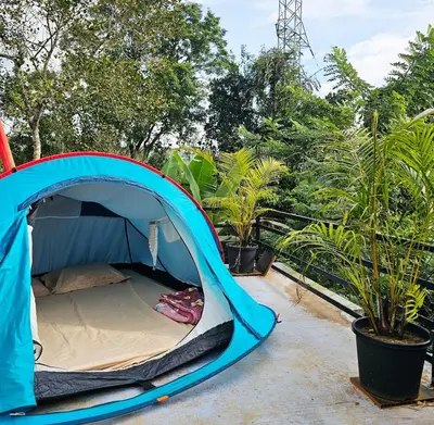 a blue tent is set up on a patio at Valiyattu Nest Homestay in Ambalavayal