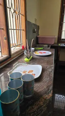 a counter with four buckets on top of it at Eden Garden Homestay in Mysore
