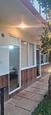 a house with large glass windows on the side of it at Fresh Wave Resort And Pool Villa Soochipara in Meppādi