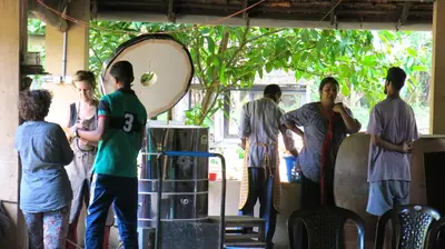 a group of people standing around in a room at Clayfingers Art Cottage in Trichūr