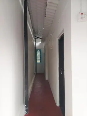 a corridor of an empty room with a long hallway at Haven heights in Kanthalloor