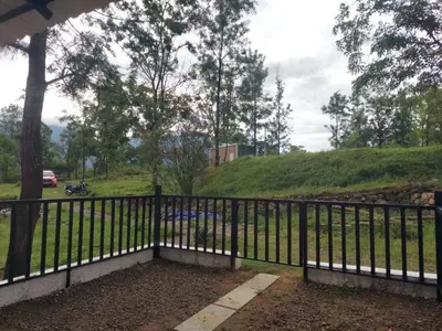 a black fence with a view of a hill at Haven heights in Kanthalloor