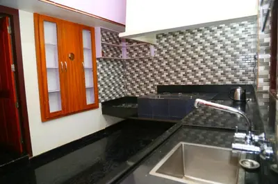 a kitchen with a sink and a counter top at Whispering Streams in Tariyod