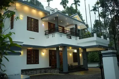 a white house with a balcony on top of it at Whispering Streams in Tariyod