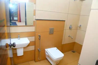 a bathroom with a toilet and a sink at Whispering Streams in Tariyod