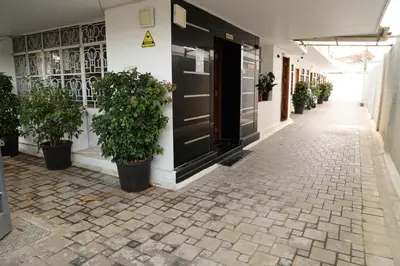 a corridor of a building with potted plants at Aaru Residency in Coimbatore