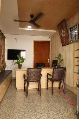 an office with two chairs and a desk with a computer at Aaru Residency in Coimbatore