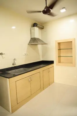 a kitchen with a sink and a ceiling at Aaru Residency in Coimbatore