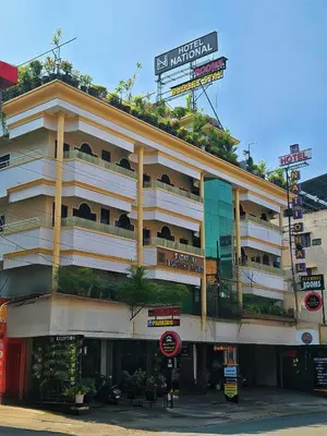 a large building with plants on the top of it at Hotel National Tourist Home in Trichūr