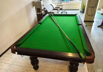 a green pool table in a room at Hotel National Tourist Home in Trichūr