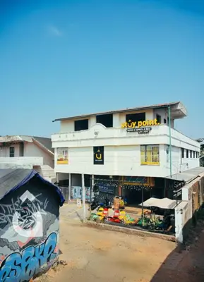a large white building with graffiti on the side of it at Stay Point Premium Capsule and Rooms in Calicut Beach in Kozhikode