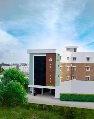 a building with a sign on the side of it at Hotel Vishaka Paark in Coimbatore